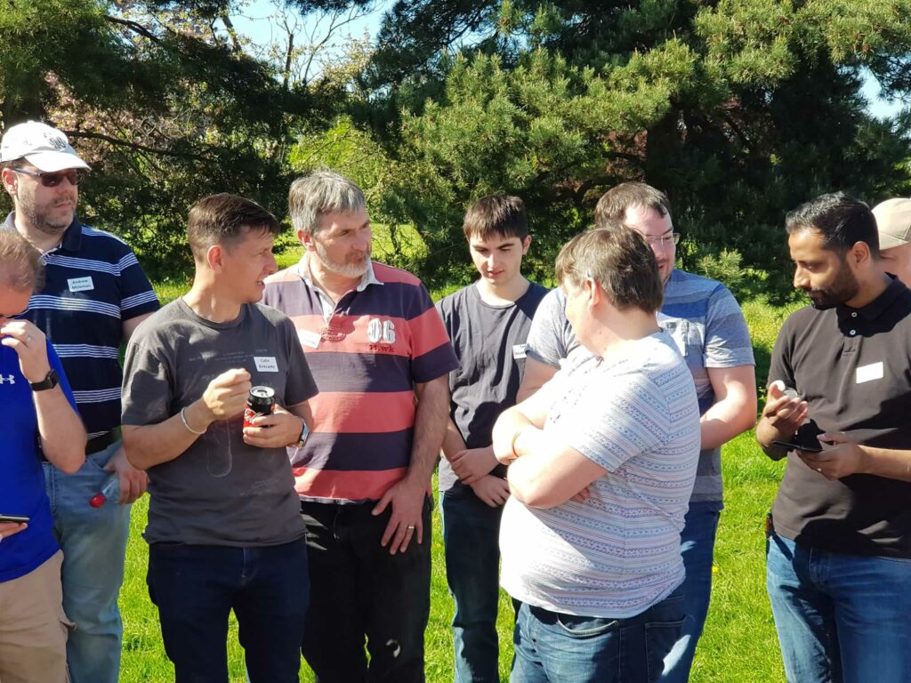 group of men talking outdoors