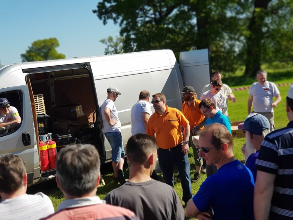 van unloading fireworks with group watching