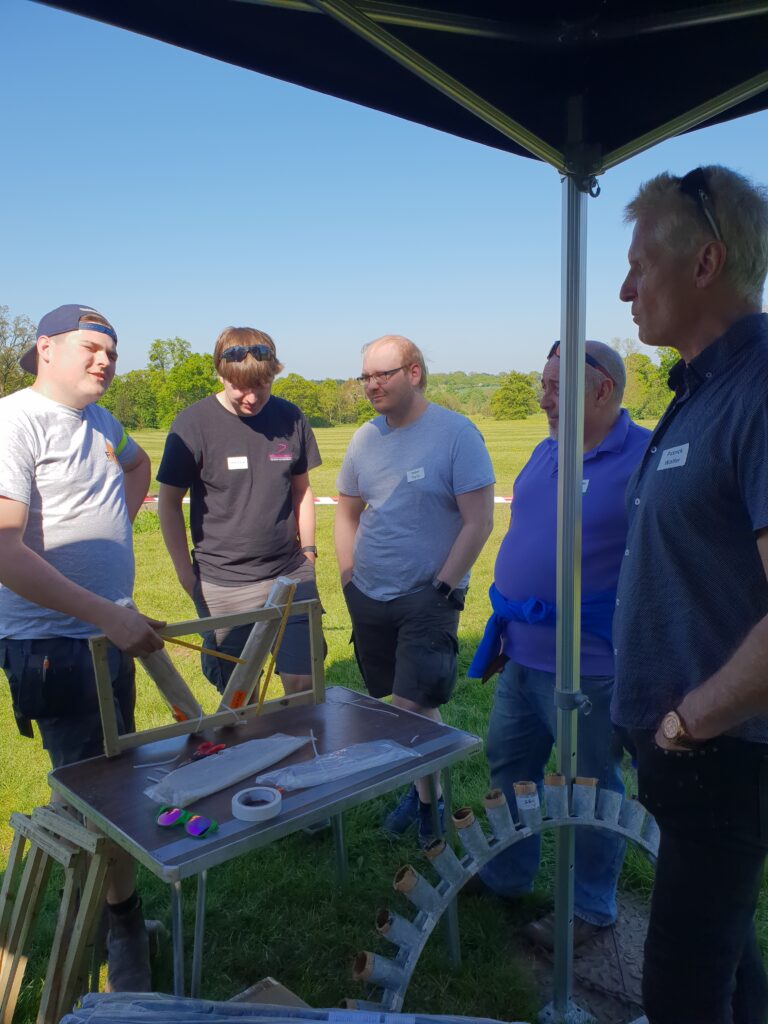 group of men surrounding firework display set up