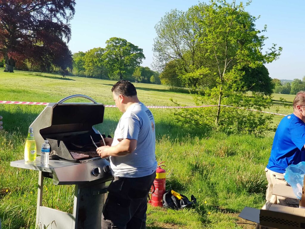 man setting up BBQ