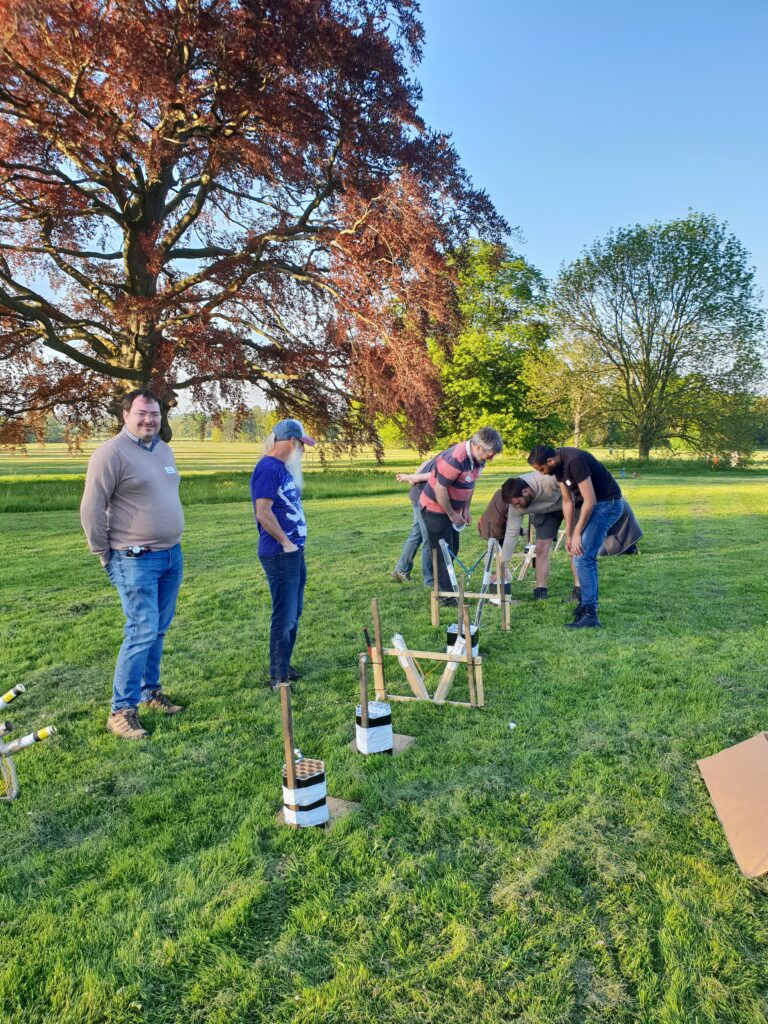 group of men setting up two firework displays, shown from another angle