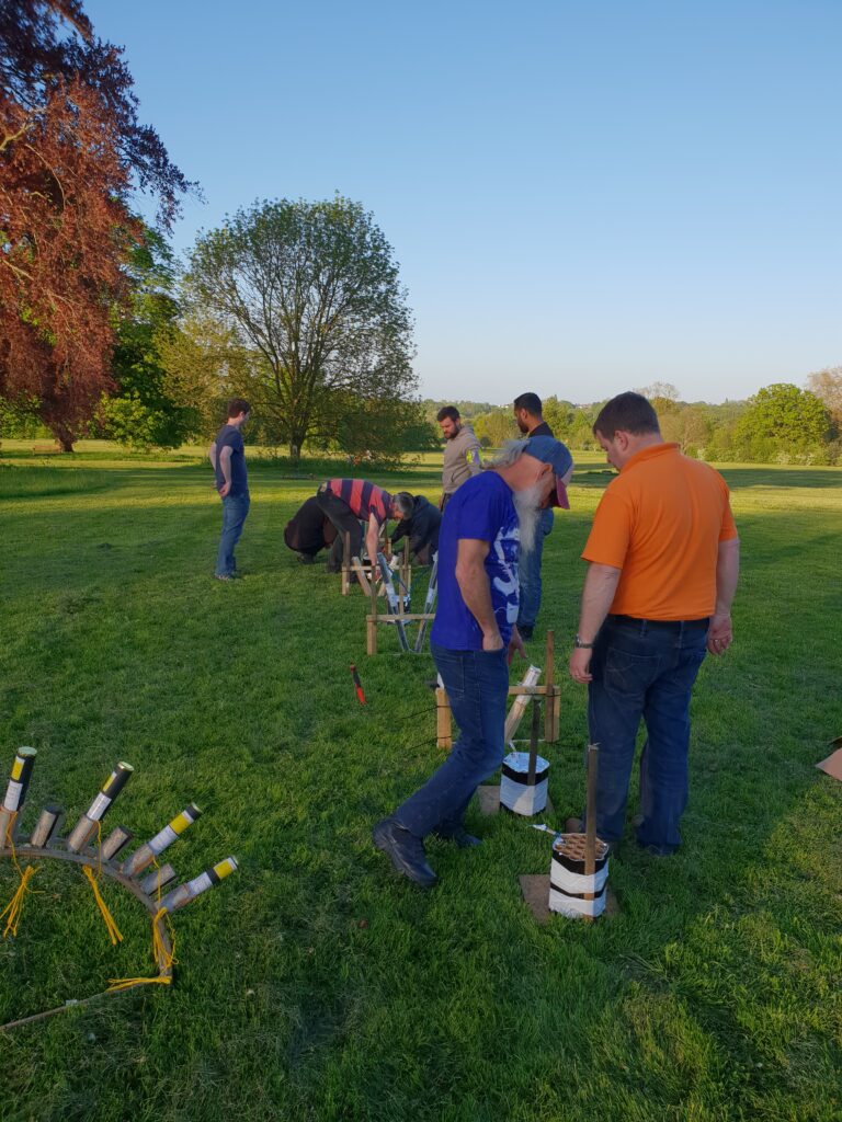 group of men setting up two firework displays