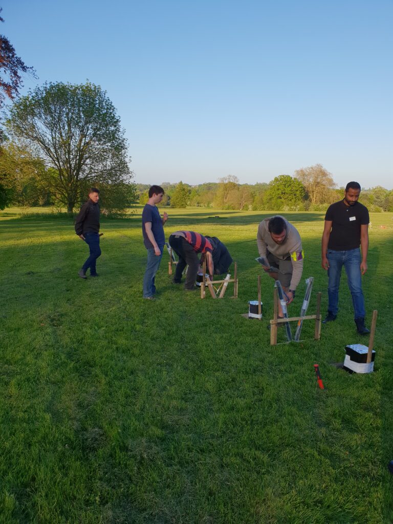 group of men setting up a row of fireworks shown from different angle
