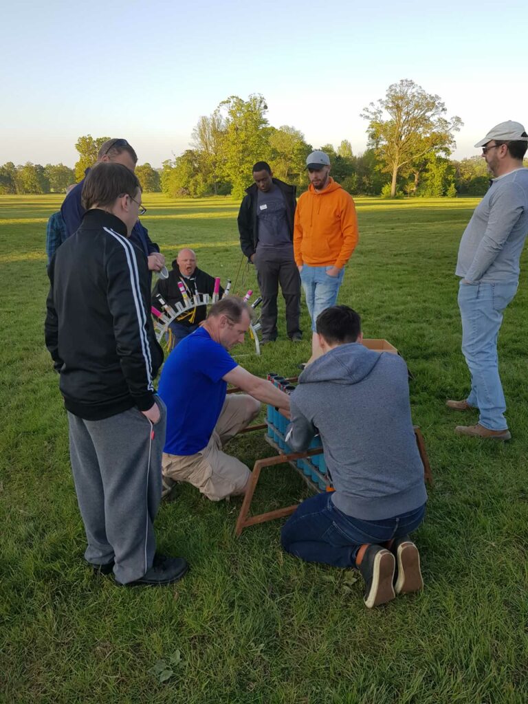 group being shown how to set up the display