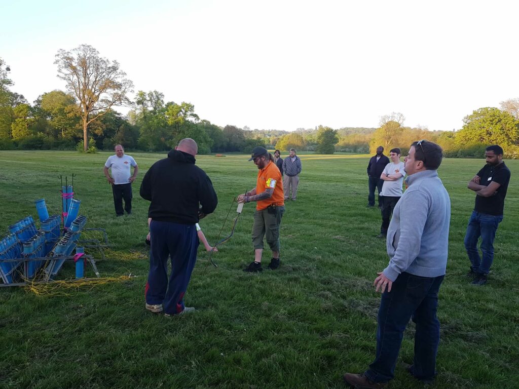 group of people watching fireworks being set up