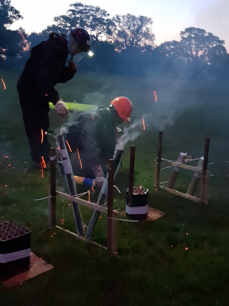 man trying to ignite firework with blowtorch safely equipped