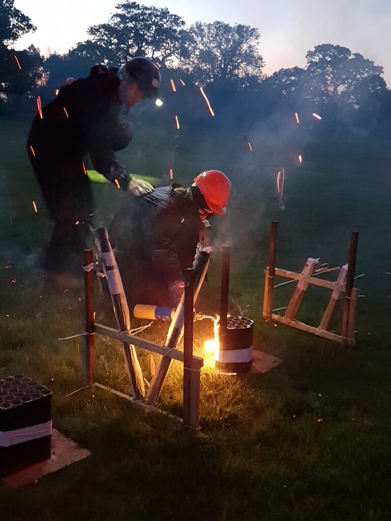 man using blowtorch to ignite fireworks safely