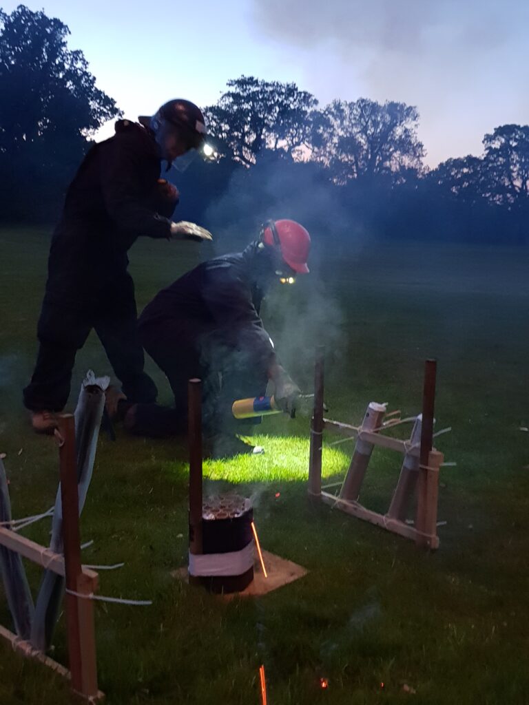 Man using blowtorch to ignite fireworks