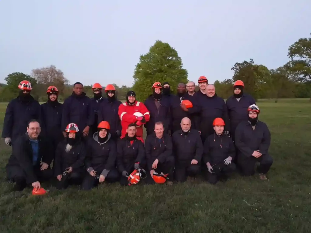 group of people at experience day at completion wearing red hard hats and PPE