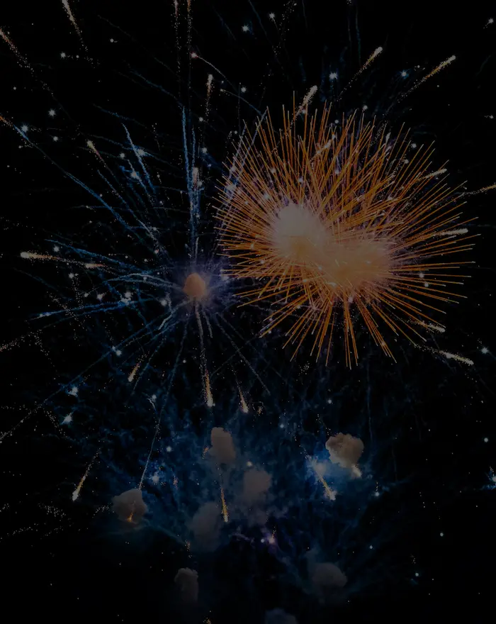 blue and orange firework display in a night sky